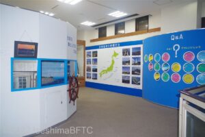 資料館の壁に掲示されているさまざまな資料。日本地図の周辺には、全国の灯台の写真が飾られている。