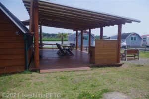 駐車場から続くキャビンの屋根付きウッドデッキのようす。