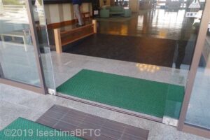 建物入口と、はいってすぐのスロープのようす。スロープの傾斜はゆるやか。